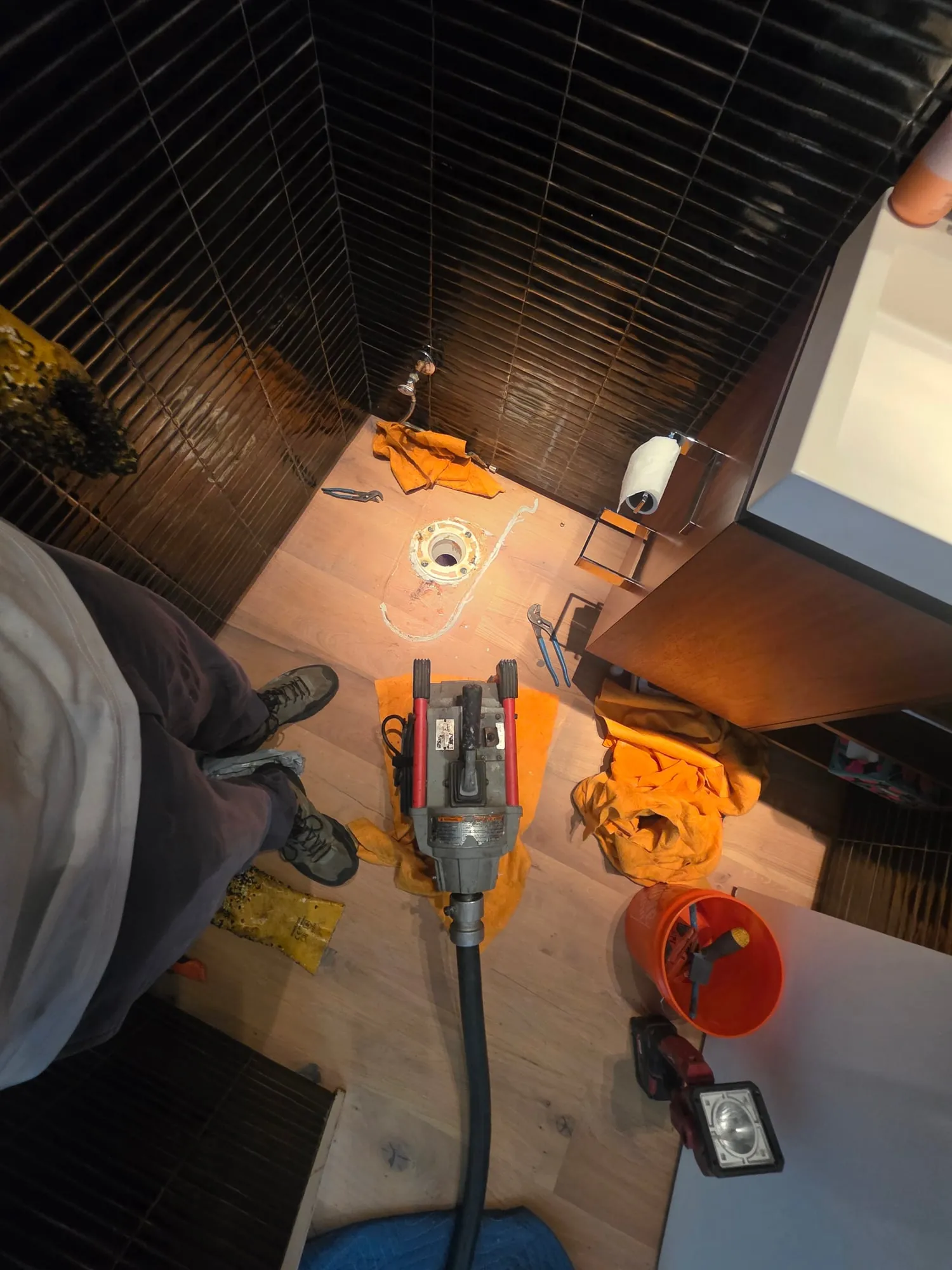 Drain machine cable fed into an open toilet flange