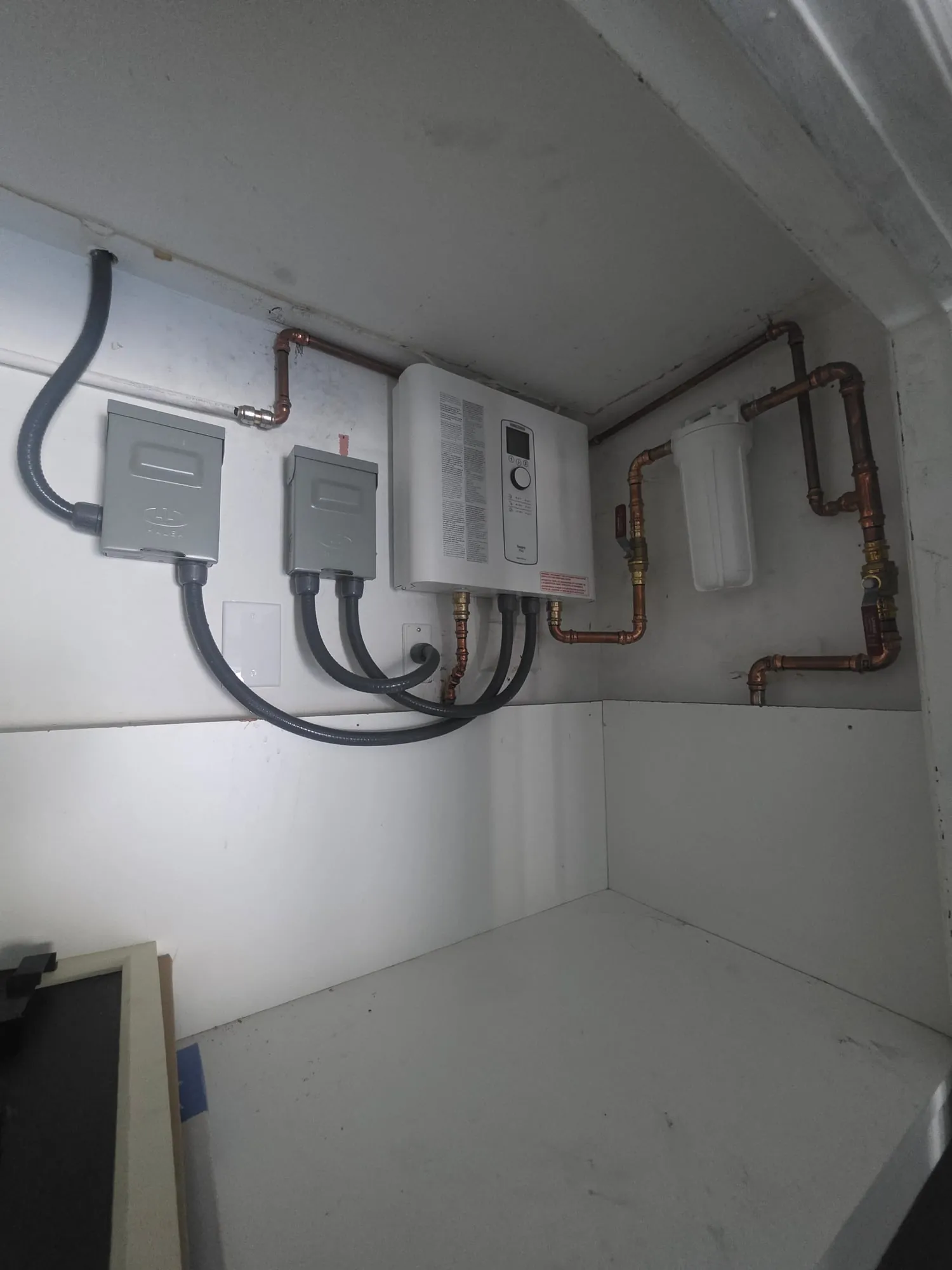 Electric tankless water heater with a whole-unit filter and copper piping
