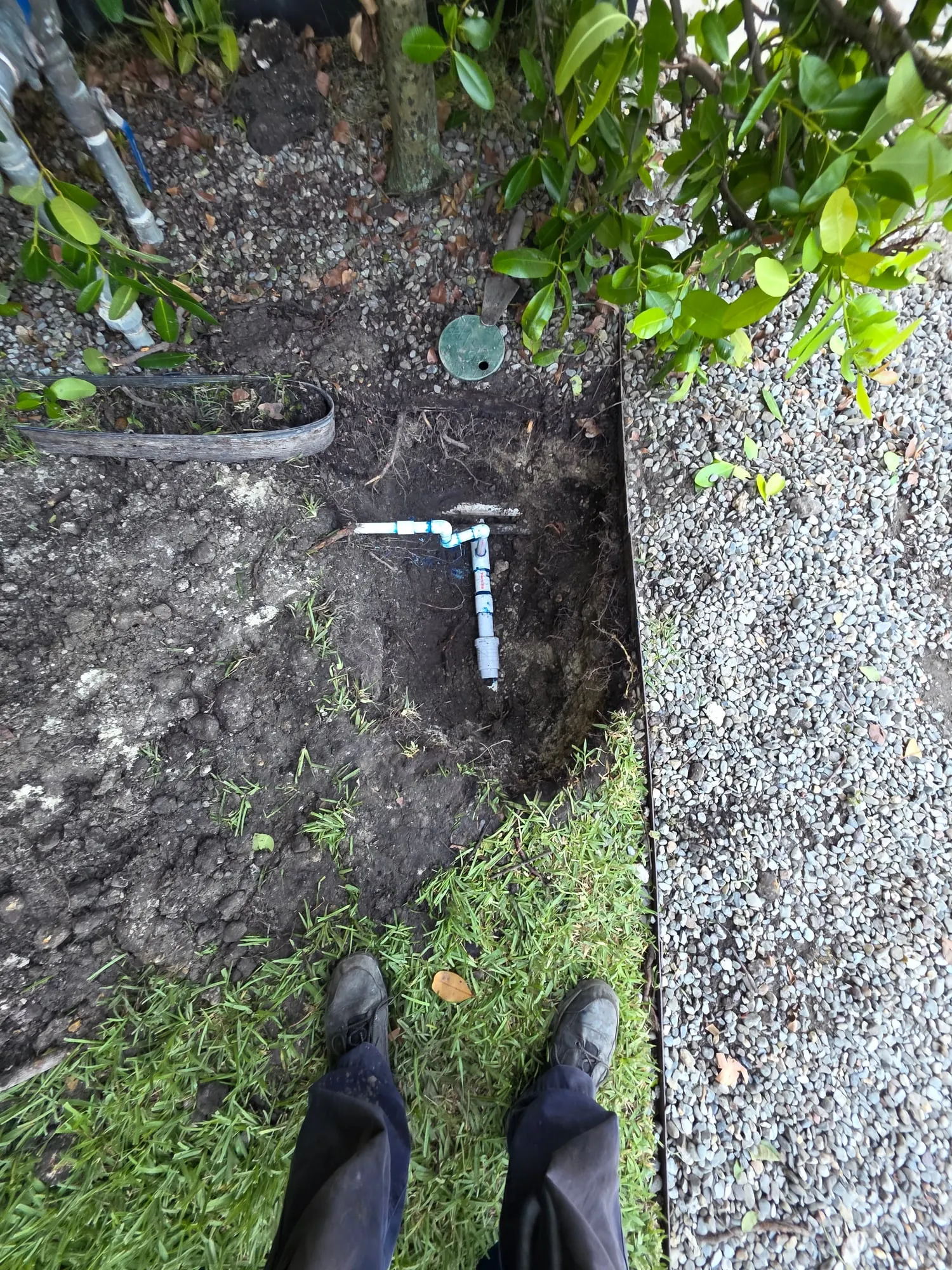 New PVC water line fitted in an open trench