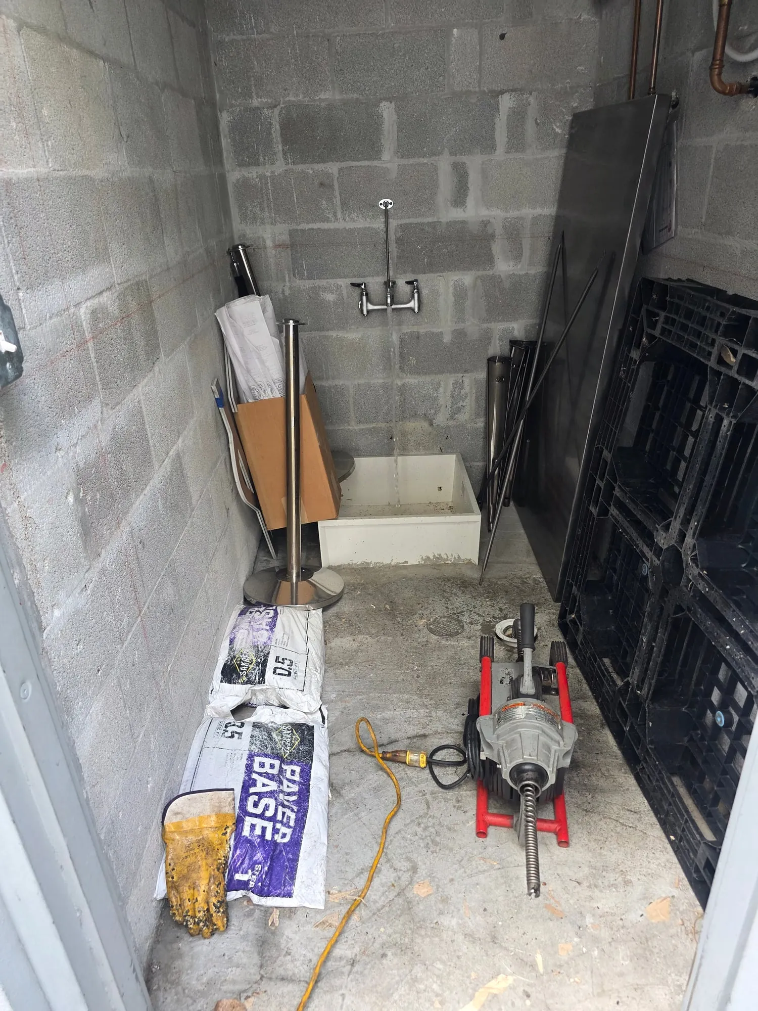 Drain machine in a utility room with a mop sink