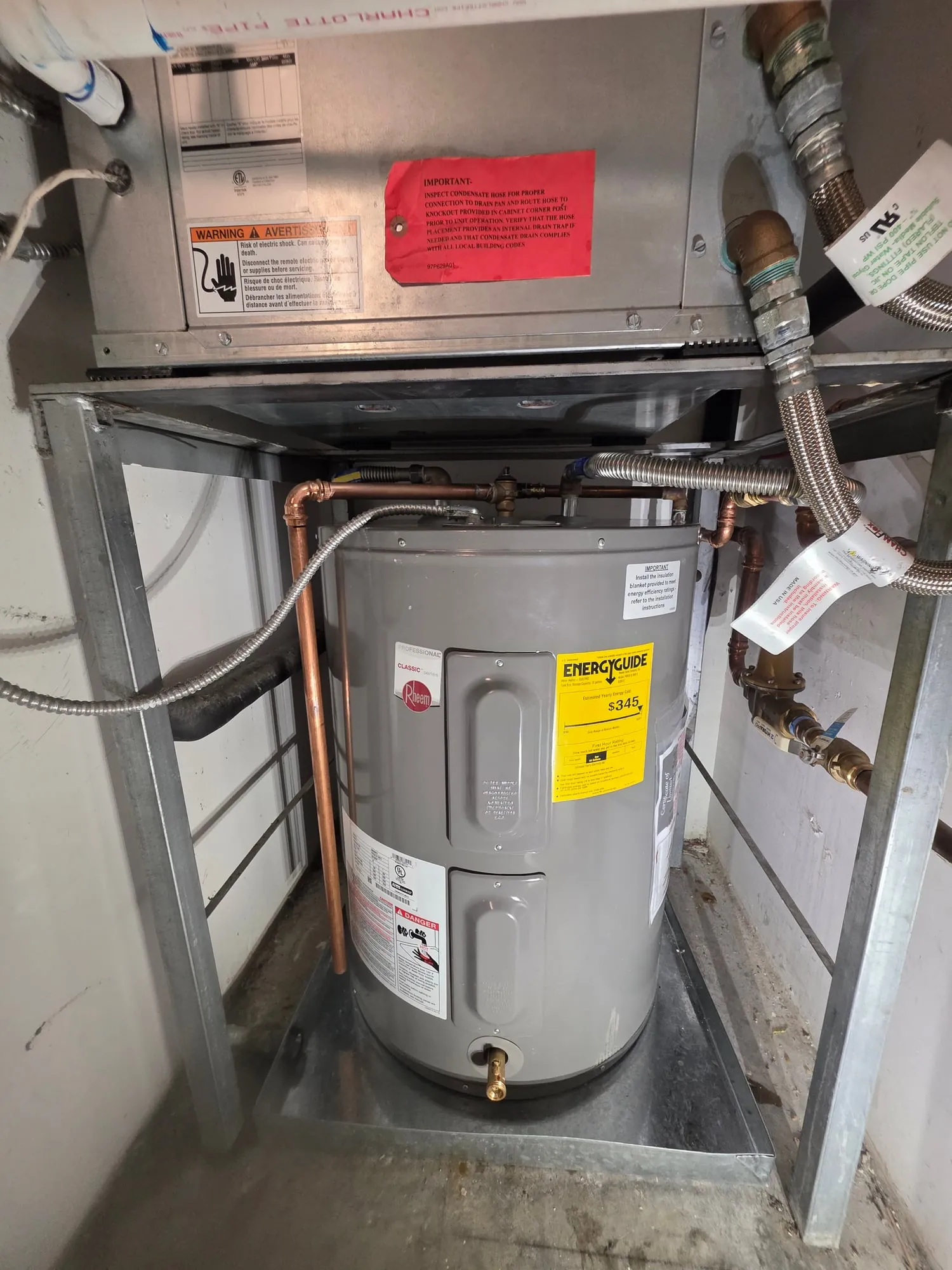 New electric water heater installed in the stand under an air handler
